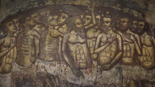 An oppressive scene in a fresco with skeletons and suffering figures in a cramped crowd situation,