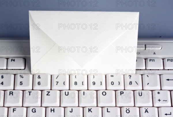 The keyboard of a computer and an envelope. Communication via e-mail, The keyboard of a computer
