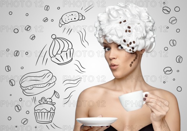 Young beautiful woman with whipped cream on her hair, with a curl of coffee beans, drinking coffee