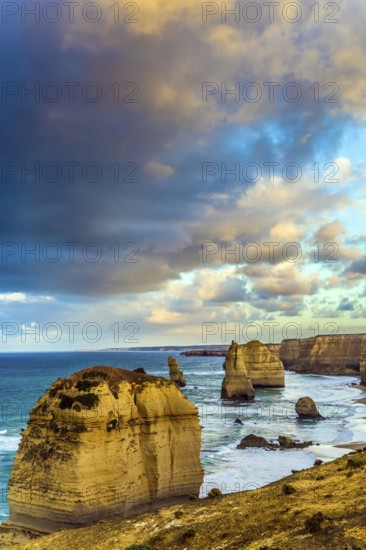 Travel to Australia. Pink dawn clouds over the rocks Twelve Apostles. Morning on the ocean shore.