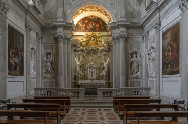 Spoleto, Italy, 25 November, 2022: altar and pews with statues and paintings inside the Spoleto