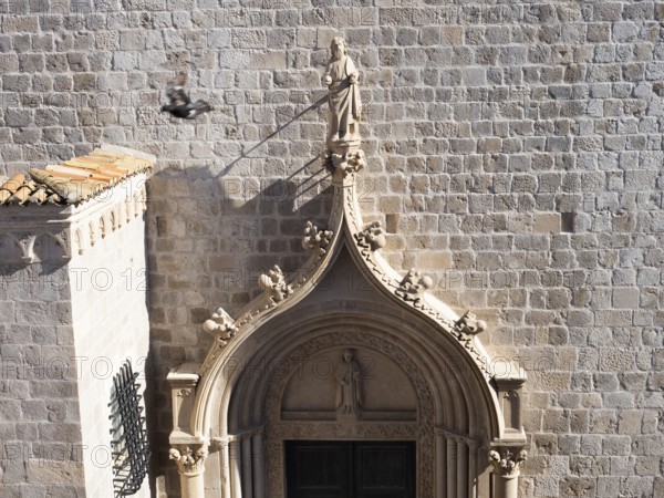 Sculpture, stone carving, figure of a saint above a church portal, Old Town of Dubrovnik, Dalmatia,