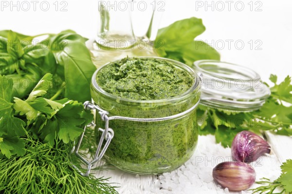 Sauce of dill, parsley, basil, cilantro, other spicy herbs, garlic and vegetable oil in a glass