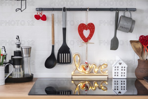 The interior of the kitchen in the house is decorated with red hearts for Valentine's Day. Decor on
