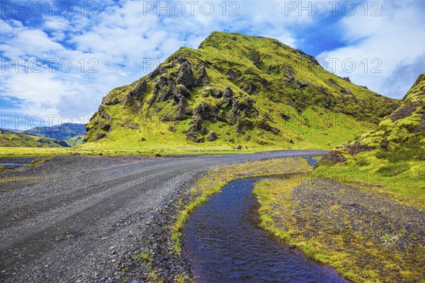 Picturesque basalt hills covered with green grass and moss-polar. At the bottom of the canyon