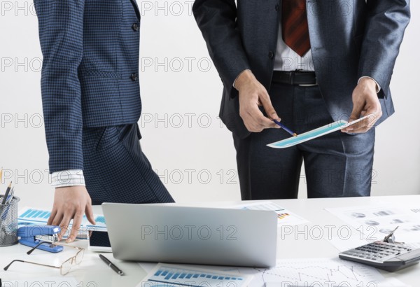 Business partnership concept with business people. Office desk with financial analytics. Business