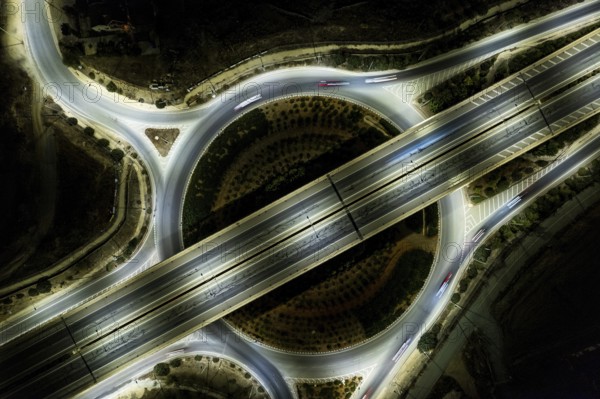 Aerial drone top view of a modern designed motorway junction. roundabout with cars moving. Cars