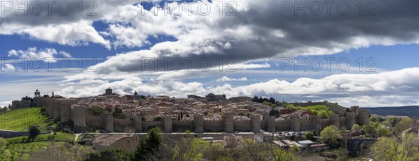 Avila, Spain, 8 April, 2024: panorama view of the medieval walled city of Avila on a beautiful