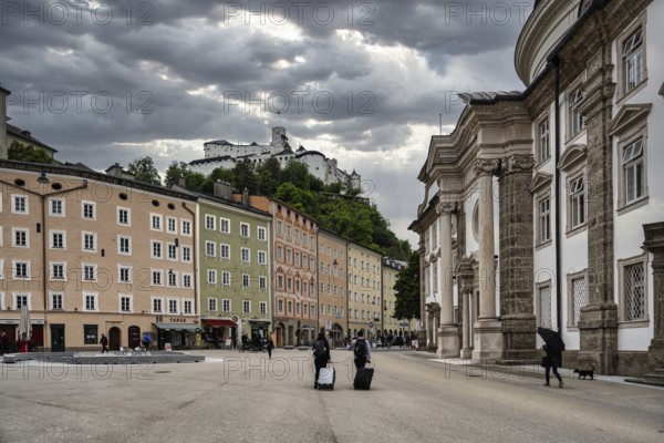 A view of the castle in Salzburg in Austria with the street scene in the foreground