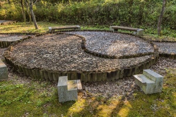 Yin yang symbol made of wooden posts and cemented rocks in wilderness park, Gongju, South Korea,