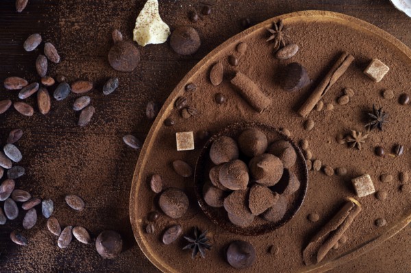 Healthy delicious chocolate truffles around ingridients with natural cocoa beans, powder, cacao