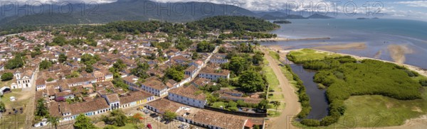 Panoramic aerial view to historic town Paraty with green mountains and sea in background on a sunny