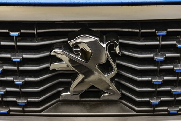 WETZLAR, Germany 2022-04-23: Peugeot logo closeup on a car grill. Peugeot as car manufacturer was