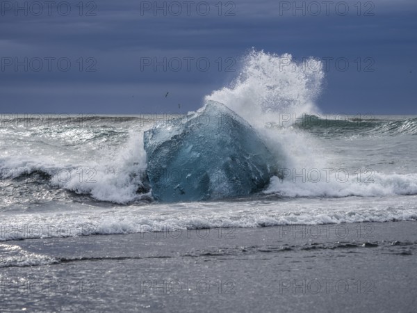 Diamond Beach, iceberg in the surf, near Jökulsarlon glacier lagoon, Vatnajökull National Park,