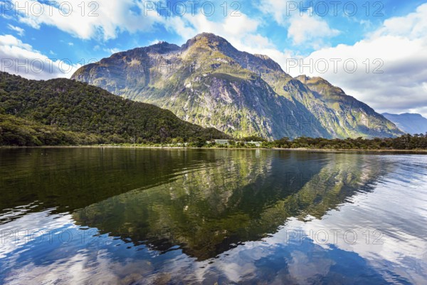 The mountains are reflected in the smooth water of the fjord. The most famous and picturesque fjord