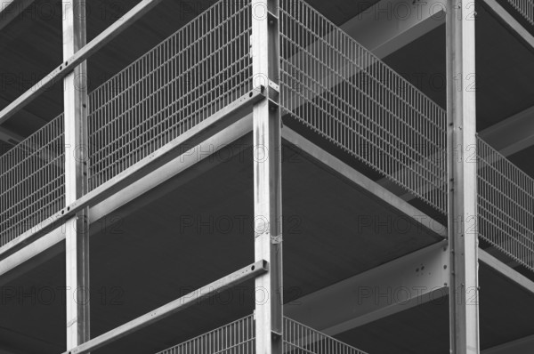Architectural detail of a modern building highlighting steel beams and metal grids, creating a