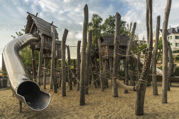 Children's playground with wooden huts, climbing equipment and slide, Bodman-Ludwigshafen,