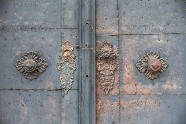 Door handle, ornate wrought ironwork, church door of the Church of the Merciful Brothers, Graz,