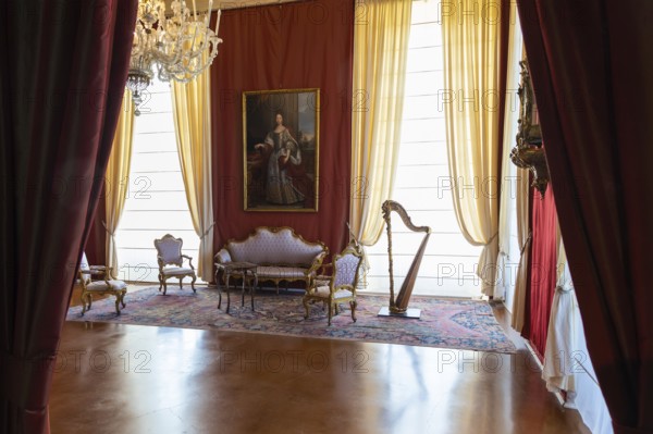 Venaria Reale, Italy, February 2023: luxury interior, old Royal Palace. Perspective with harp,
