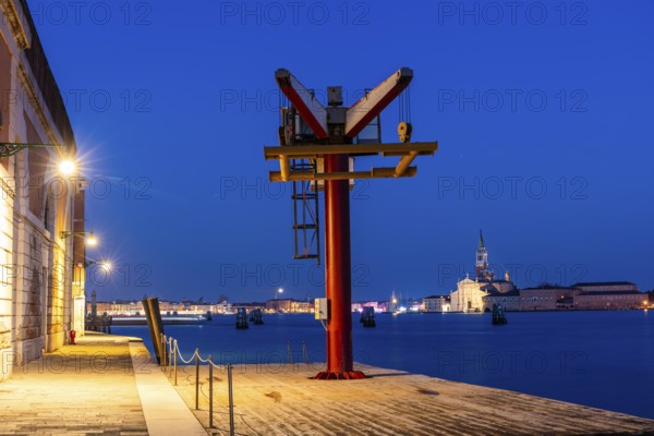 Loading crane on the quay, backlit church of San Giorgio Maggiore, blue hour, Venice, UNESCO World