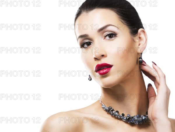Romantic woman with dramatic makeup and nailpolish. Big blue silver fashion necklace.