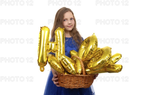 Little girl in a festive blue dress holds a golden set of happy birthday inflatable letters.