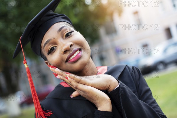 Belarus, the city of Gomil, 01 July 2020. Street in the city. African American in graduation hat,
