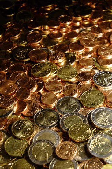 Euro coins of all denominations fill the motif. Portrait format. Euros of all coin values fill in