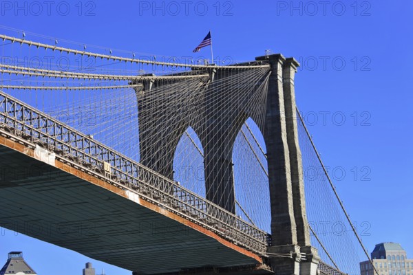 Brooklyn Bridge in Brooklyn, Manhattan, New York, section of a bridge with waving American flag and