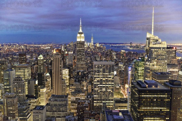 Rockefeller Center observation deck, panoramic view of the dense New York City skyline, lights of