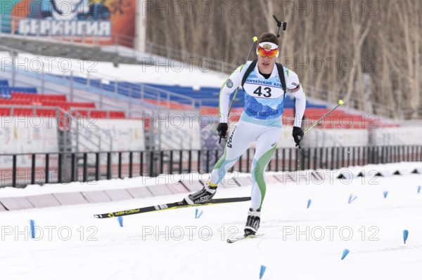 Sportsman biathlete Zlobin Vladislav Khanty-Mansiysk skiing on distance biathlon stadium. Open