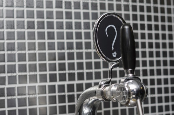 Beer tap with medallion with question mark as description