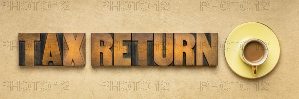 Tax return banner - word abstract in vintage letterpress printing blocks against textured paper