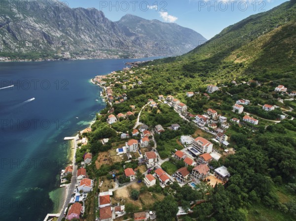 Coast of Dobrota on the shore of the Bay of Kotor at the foot of the mountains. Montenegro., Kotor