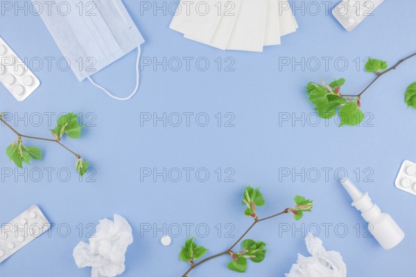 Creative flat lay concept of seasonal spring pollen allergy with napkins, pills, face mask, drops