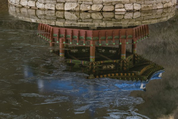 Jeongeup-si, South Korea. December 8, 2020: Reflection in water of picnic pavilion with blue roof