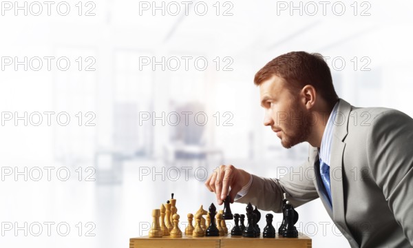 Businessman moving chess figure in chessboard. Successful management and leadership concept.