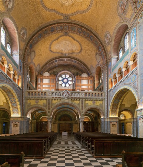 Szeged, Hungary, 14 October, 2022: view of the central nave with wooden pews and the church organ