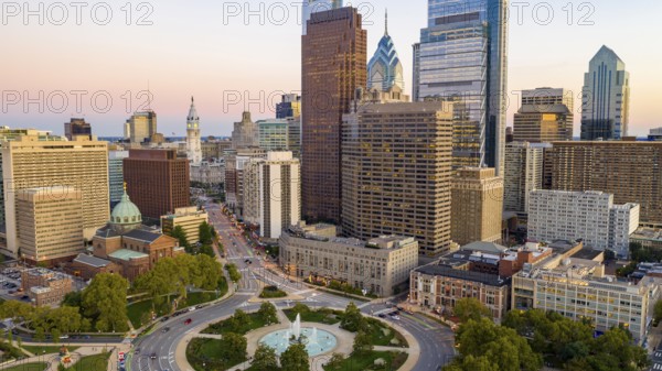 Vehilce traffic circles around the fountain at Logan Square in the bustling urban core of