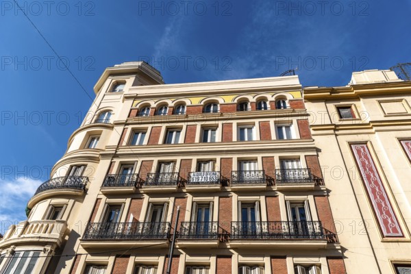 Madrid, Spain, November 1, 2020: Old residential building with iron balconies in the downtown of