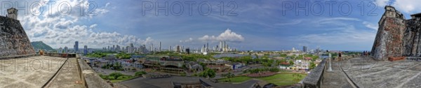 Panoramic view of a cityscape from a historical fort with a mix of urban buildings and greenery