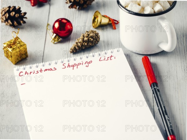 Christmas gifts shopping planning. Make shopping or to-do list for Christmas. Notebook, mug hot