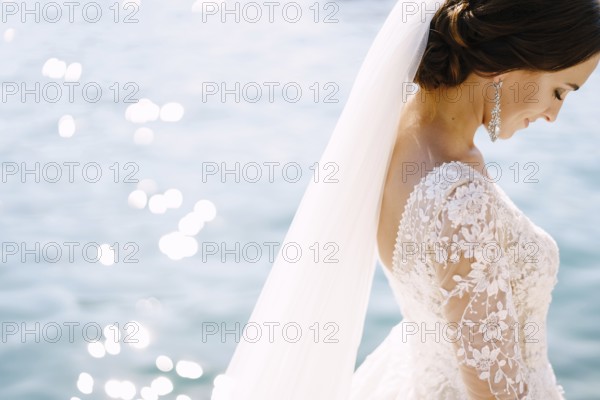 Close-up of the neck and neck of the bride, face profile. Beautiful big earring in ears, shoulder