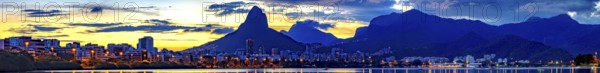 Panoramic image of summer sunset seen from the lagoon Rodrigo de Freitas with the buildings of the