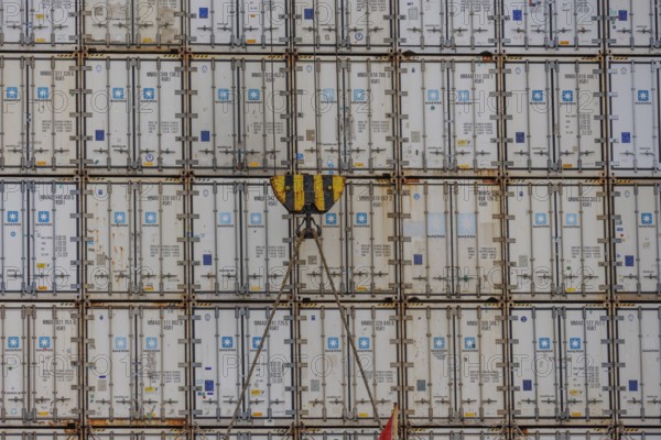 Stack of freight containers in the harbour, arranged in even rows, hook in the middle, Bremerhaven,
