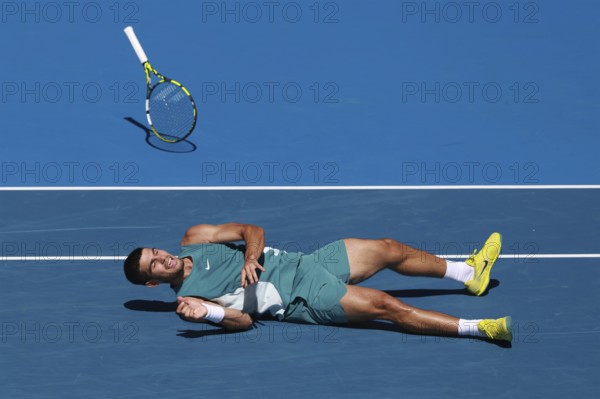 Spanish tennis player Carlos Alcaraz (ESP) diving for forehand shot and falling to the ground at