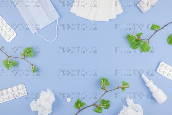 Creative flat lay concept of seasonal spring pollen allergy with napkins, pills, face mask, drops