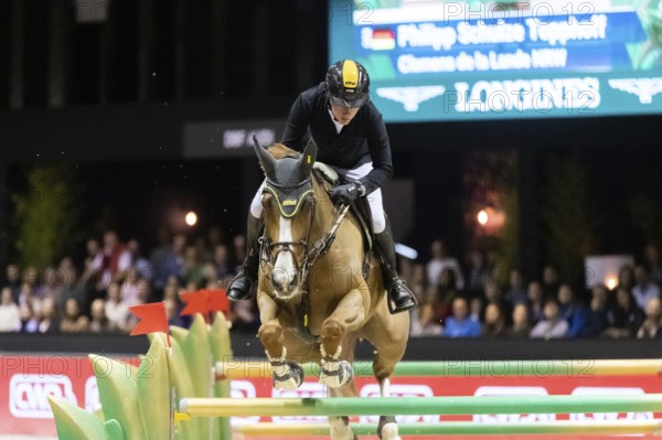 Philipp Schulze Topphoff of Germany competes in the equestrian Audi Grand Prix at Jumping