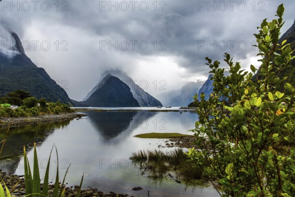 Land of hobbits and goblins. New Zealand. Storm clouds cover the sky over the ocean fjord Milford