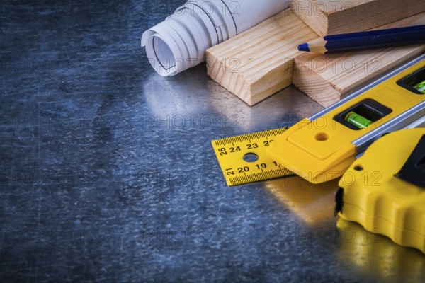 Composition of construction working tools on metallic scratched background architecture and